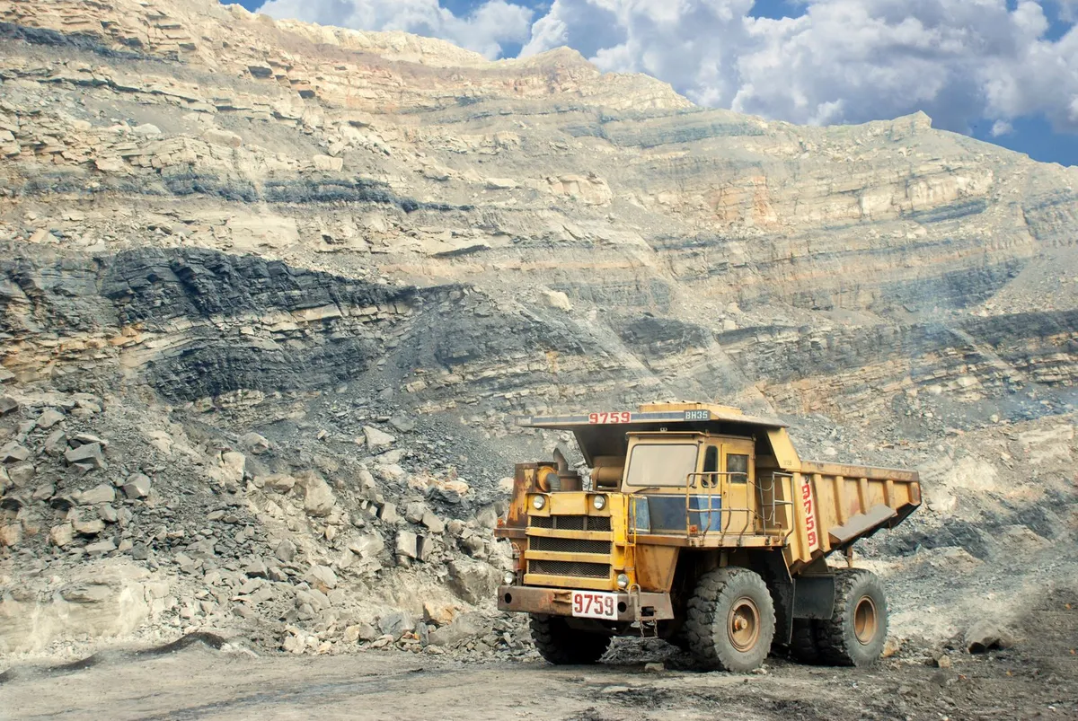 Large yellow mining haul truck in an open-pit quarry