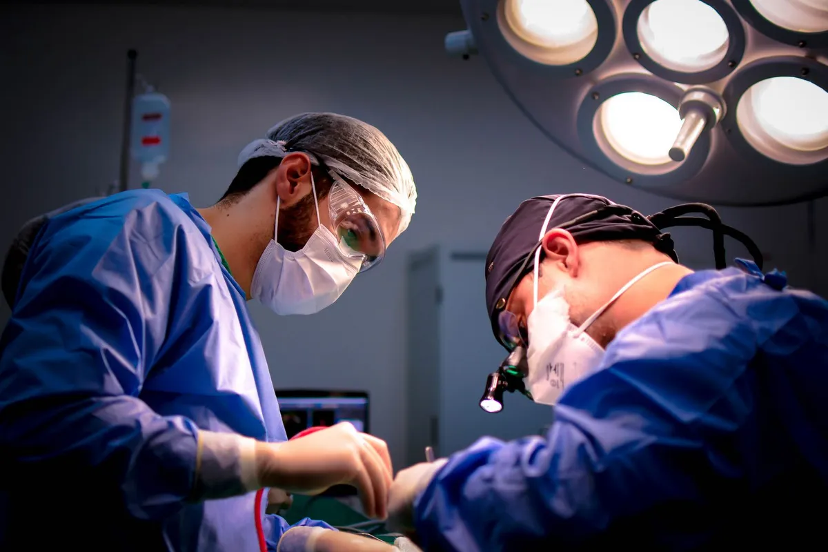 Surgeons performing an operation in a hospital operating room